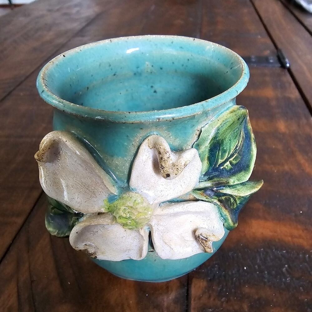 Gorgeous Teal pottery vase with dogwood bloom.